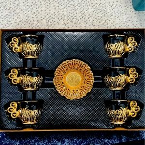 Beautiful gold and black Turkish tea cups with matching gold saucers